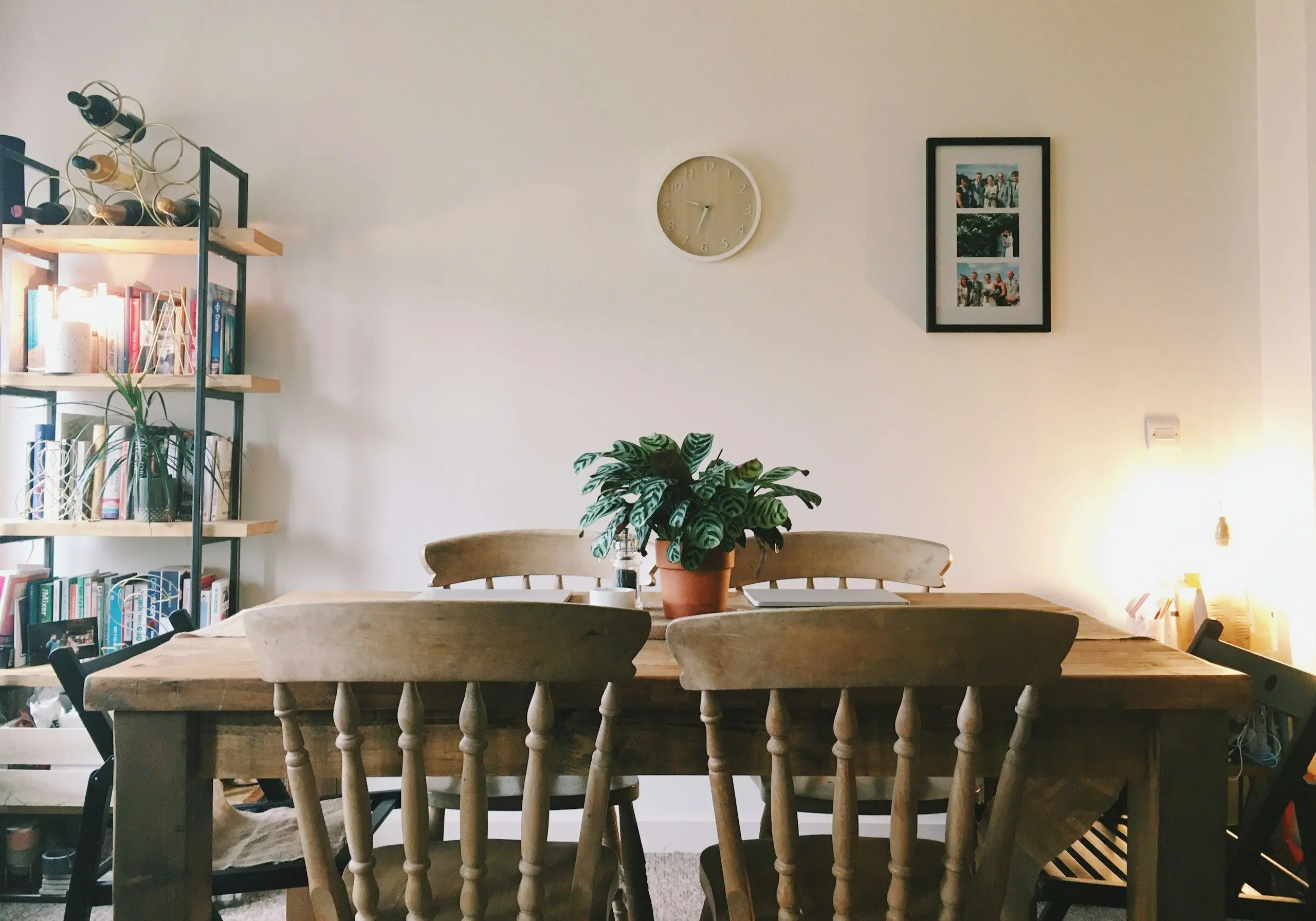 A wooden dining table and chairs in a bright, homely room